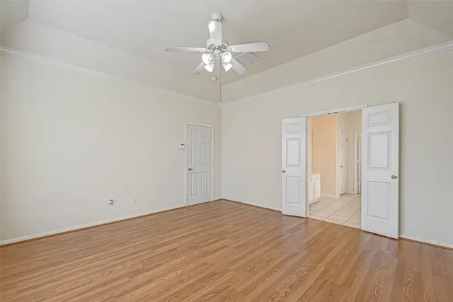 a view of an empty room with wooden floor