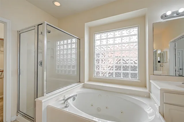 a white bath tub sitting next to a shower