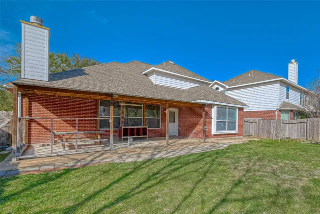 a view of a house with a yard and sitting area