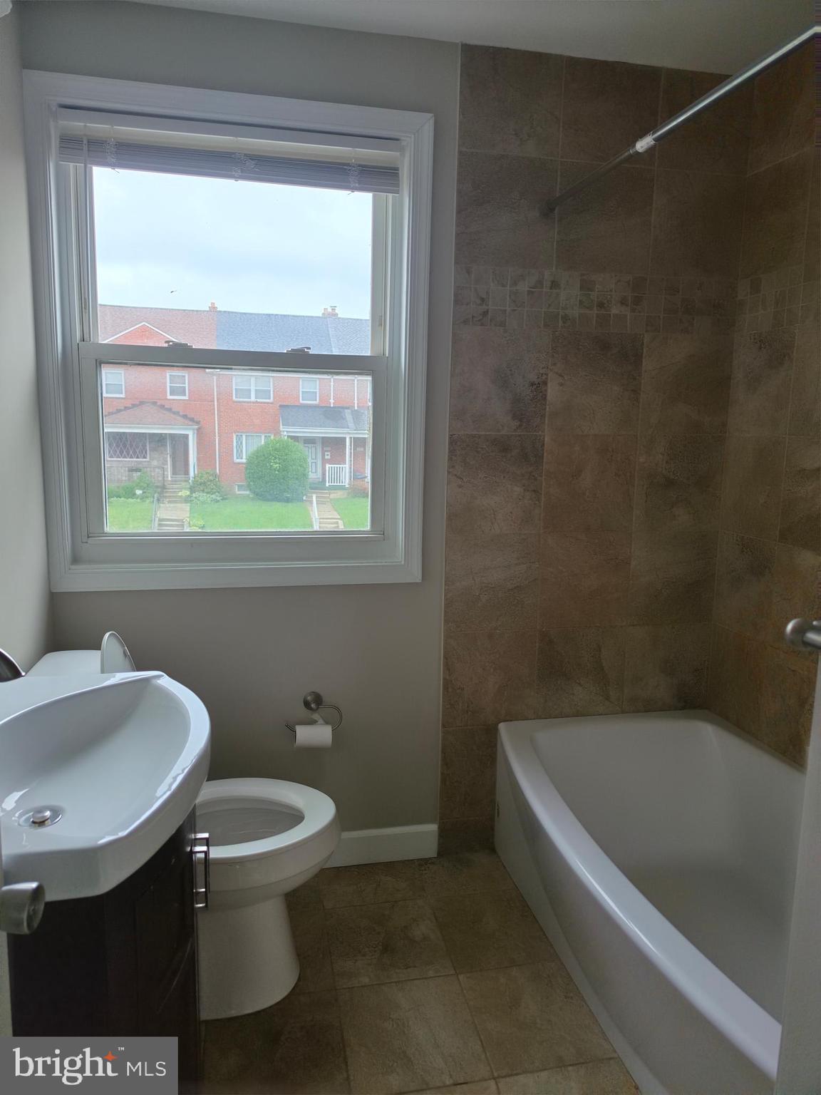 2028 Hillenwood Road Baltimore, MD 21239 - Photo 12 of 18 a bathroom with a toilet a sink and a bathtub