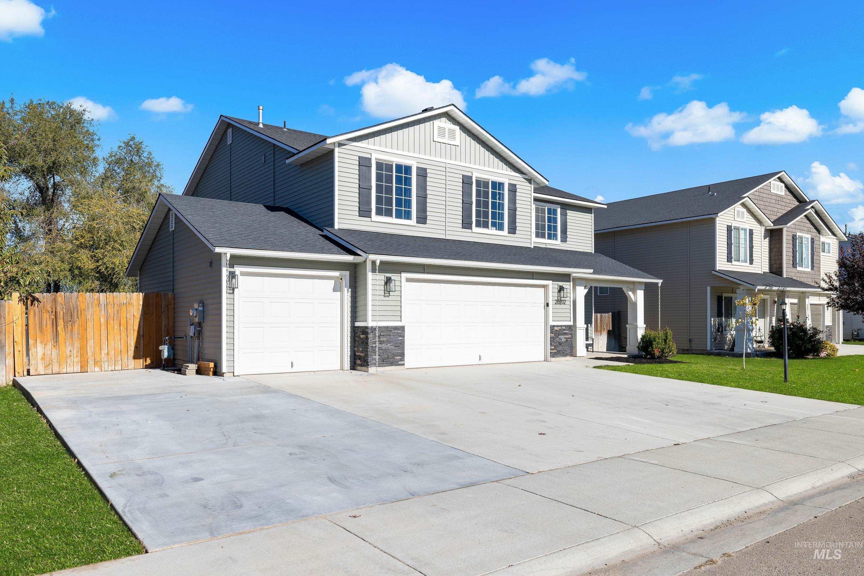 20202 Jennings Way Caldwell, ID 83605 - Photo 2 of 30 View of front facade featuring concrete driveway, an attached garage, stone siding, and a shingled roof