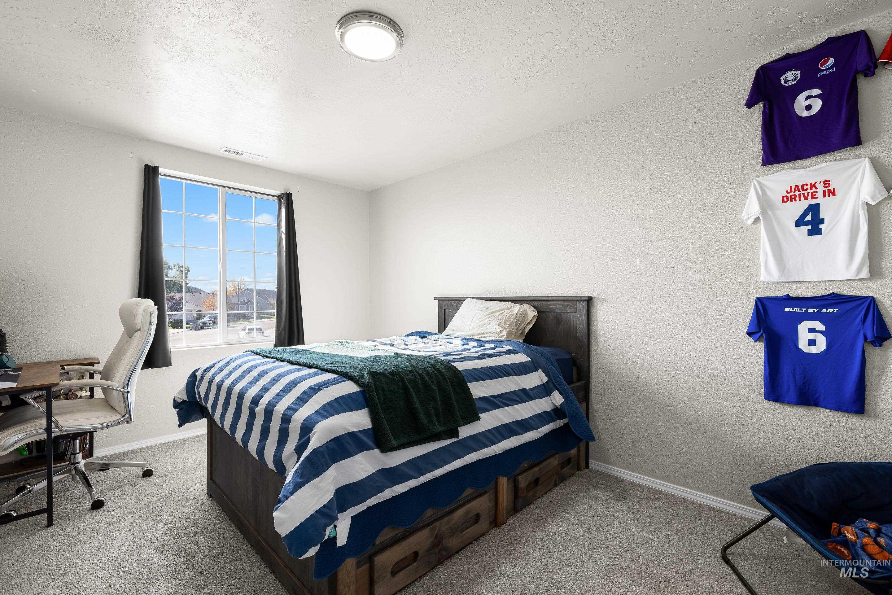 20202 Jennings Way Caldwell, ID 83605 - Photo 24 of 30 Bedroom featuring a textured ceiling, an office area, light carpet, and a textured wall