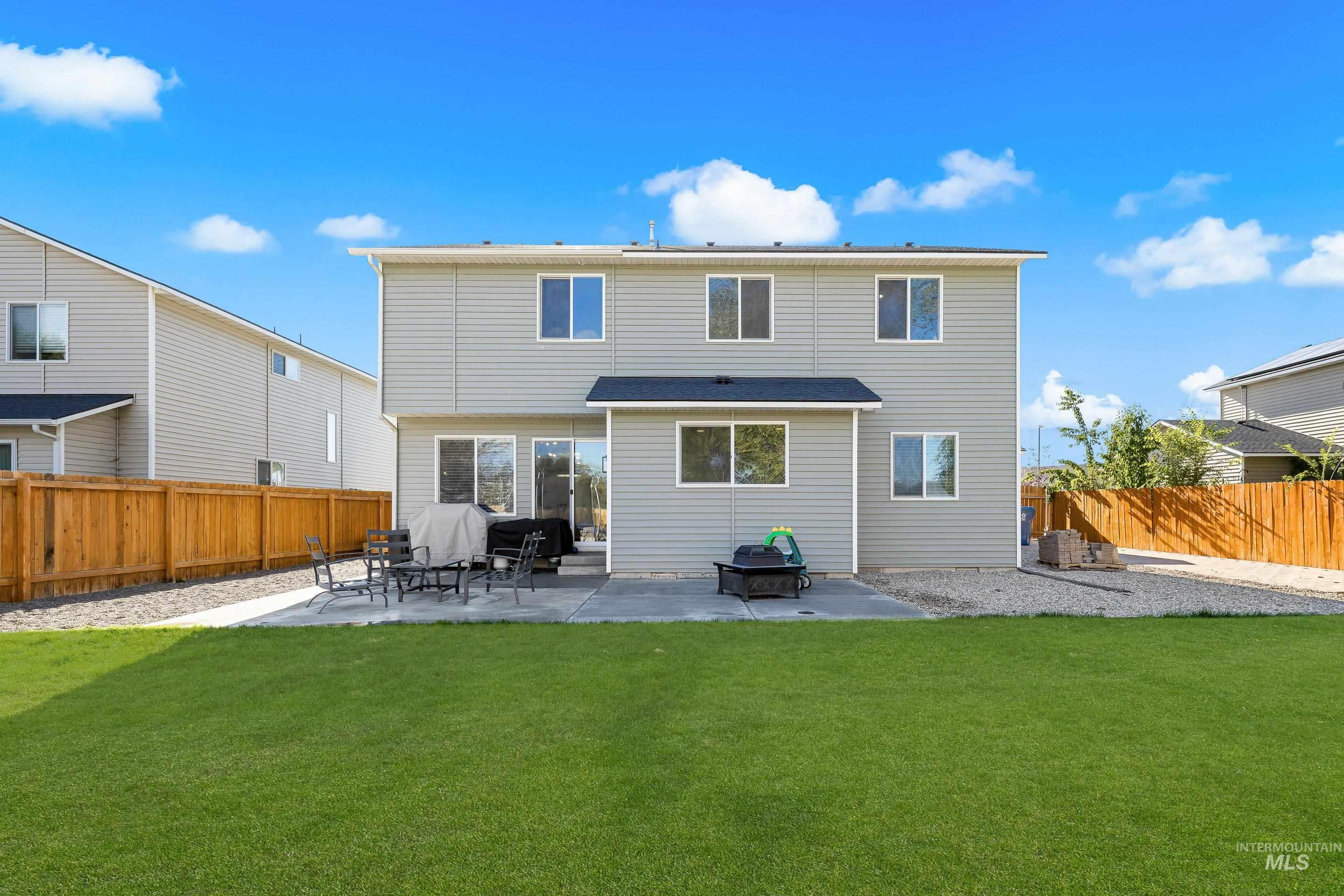 20202 Jennings Way Caldwell, ID 83605 - Photo 28 of 30 Rear view of house with a patio and a fenced backyard