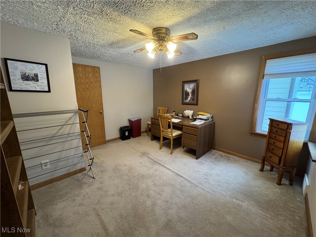 2644 Harpster Road Rittman, OH 44270 - Photo 13 of 20 Bedroom area featuring a ceiling fan, light carpet, and a textured ceiling