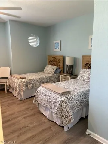 a spacious bedroom with a bed and a chandelier