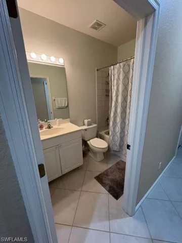 a bathroom with a double vanity sink a mirror and a bathtub