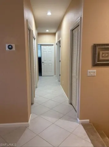 a dining room with furniture a chandelier and window