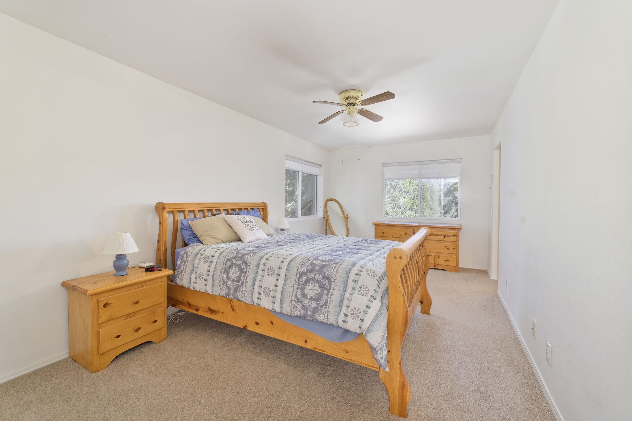 492 John Muir Road Mammoth Lakes, CA 93546 - Photo 20 of 33 Wall-to-wall carpeting, ceiling fan, and multiple windows