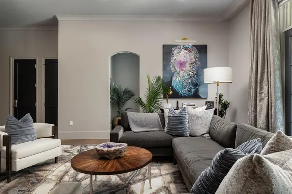 a living room with furniture and a lamp