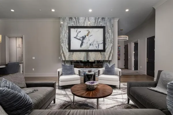a living room with fireplace furniture and a rug