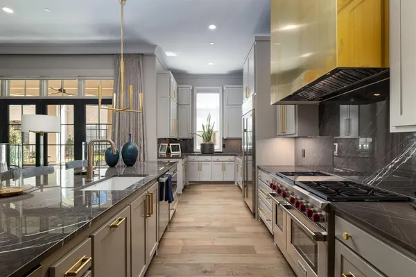 a kitchen with stainless steel appliances a sink stove and cabinets