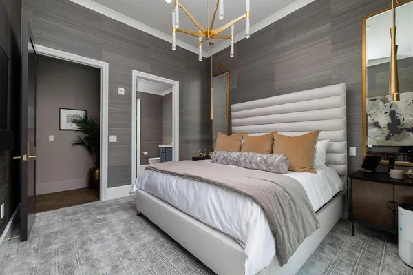 a bedroom with a bed and a chandelier