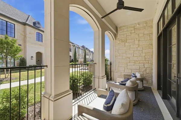 a view of balcony with couch and chairs