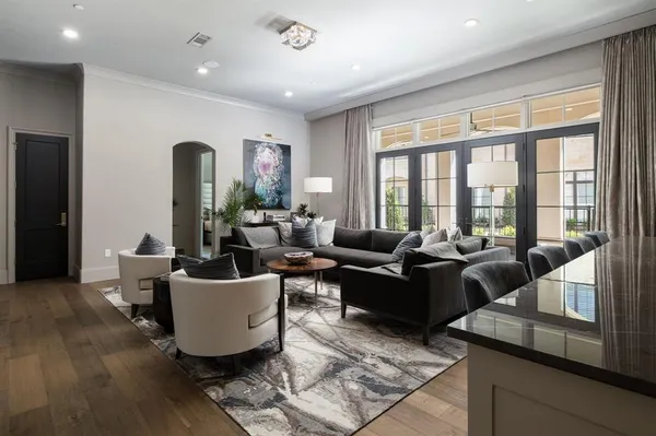 a living room with furniture and large windows