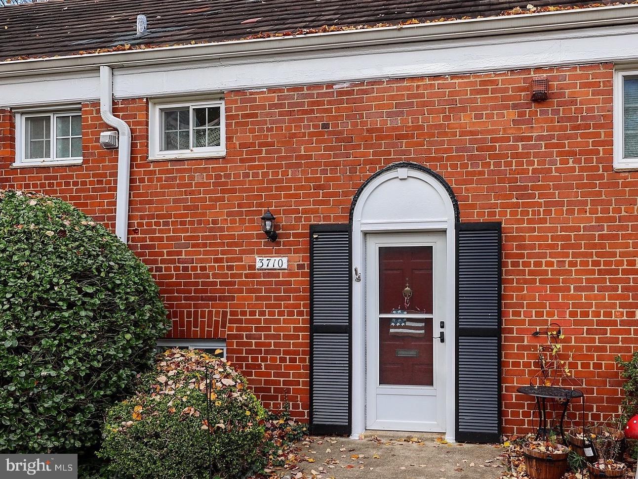 a view of a brick house with a large door