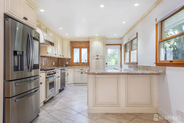 a large white kitchen with a large window