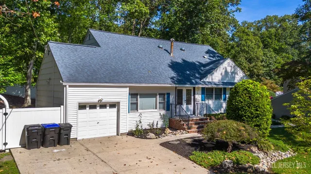 a front view of a house with a garden and plants