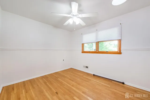 a view of a room with wooden floor and a window