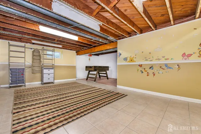 a view of a backyard with table and chairs potted plants and a large tree
