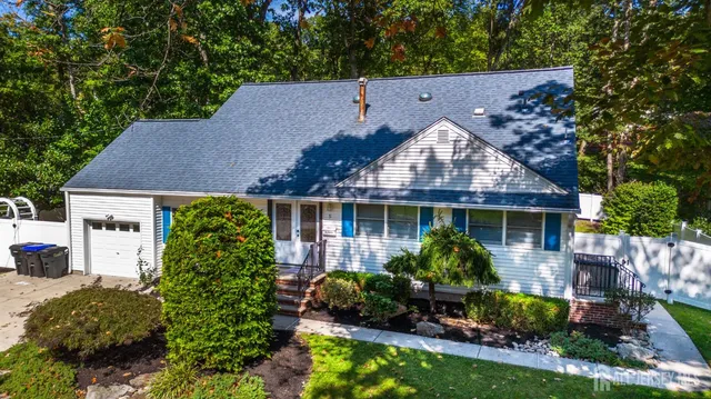 an aerial view of a house with swimming pool garden and patio