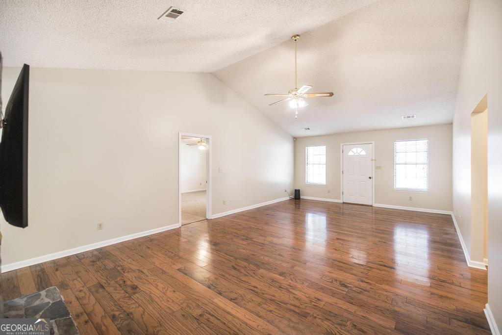 925 West Tanglewood Drive Dublin, GA 31021 - Photo 11 of 43 an empty room with wooden floor and windows