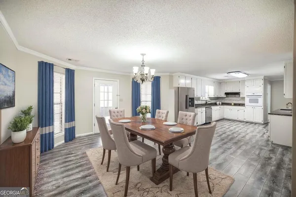 a kitchen with granite countertop white cabinets and a sink