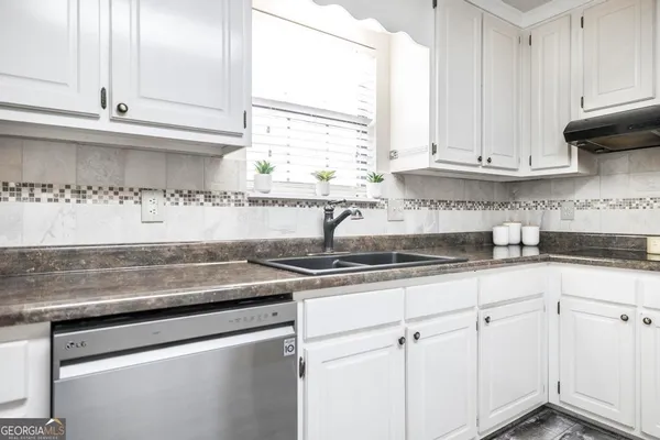 a room with a sink and cabinets