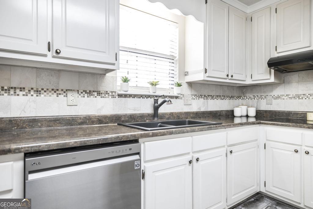 925 West Tanglewood Drive Dublin, GA 31021 - Photo 16 of 43 a kitchen with granite countertop white cabinets and a sink