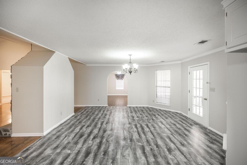 925 West Tanglewood Drive Dublin, GA 31021 - Photo 20 of 43 a view of empty room with wooden floor and fan