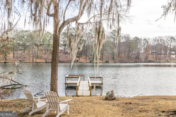 a view of a house with pool and a fire pit