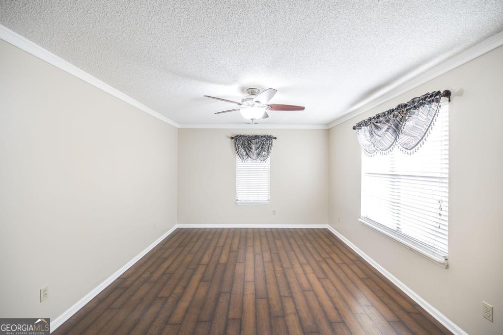 925 West Tanglewood Drive Dublin, GA 31021 - Photo 22 of 43 wooden floor in an empty room with a window