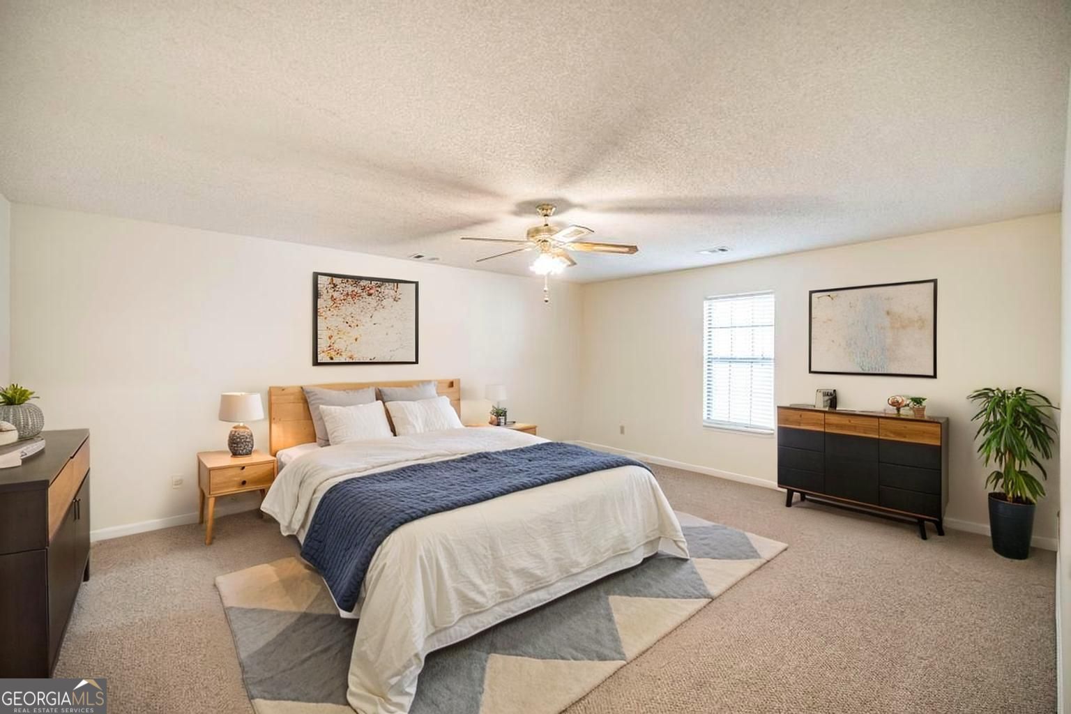925 West Tanglewood Drive Dublin, GA 31021 - Photo 23 of 43 a bedroom with a bed and a chandelier