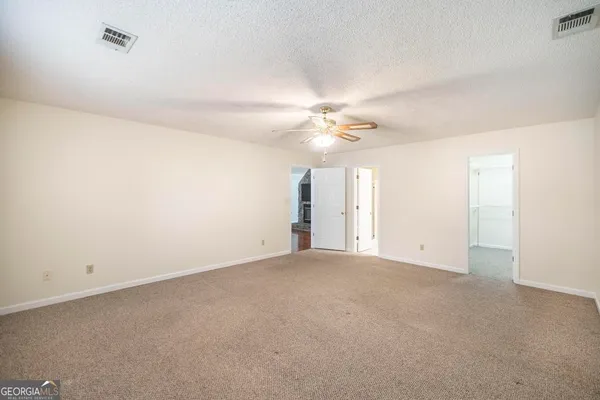a view of walk in closet with empty racks
