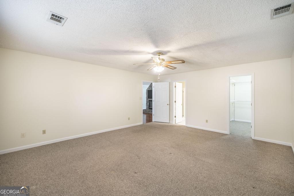 925 West Tanglewood Drive Dublin, GA 31021 - Photo 24 of 43 an empty room with a chandelier fan and windows