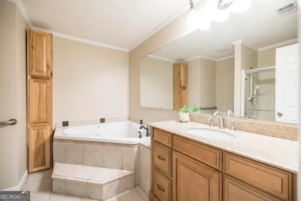 an empty room with windows and chandelier fan
