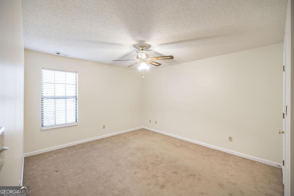 925 West Tanglewood Drive Dublin, GA 31021 - Photo 27 of 43 an empty room with windows and chandelier fan