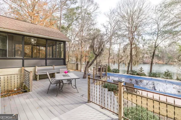 a view of a white house with a yard