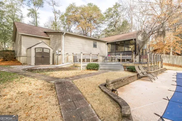 a front view of a house with a yard covered in snow