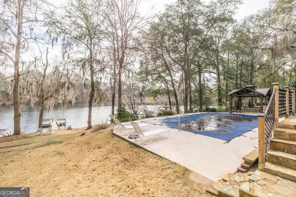 a swimming pool with outdoor seating and yard