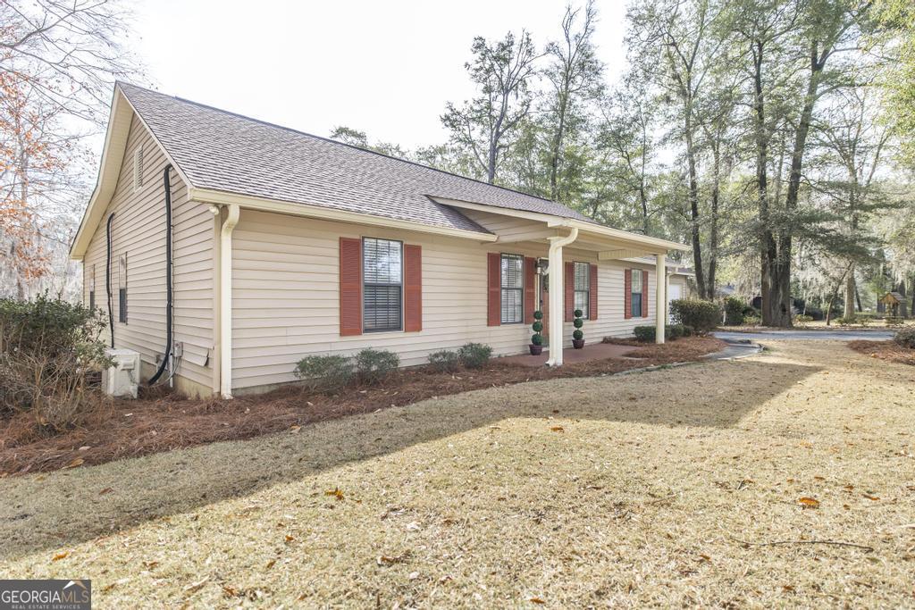 925 West Tanglewood Drive Dublin, GA 31021 - Photo 42 of 43 a view of a yard and a house with a backyard