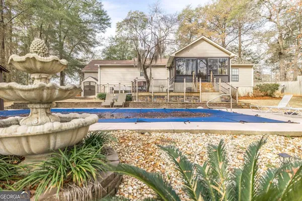 a front view of a house with a garden
