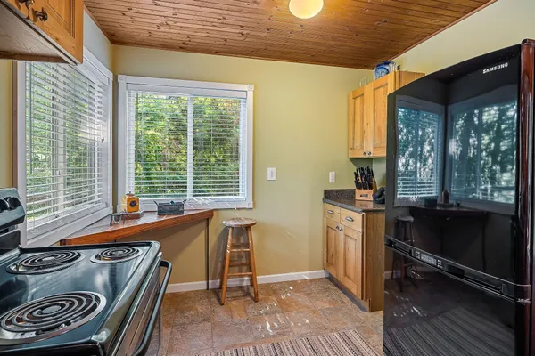 a kitchen with stainless steel appliances granite countertop a sink and cabinets