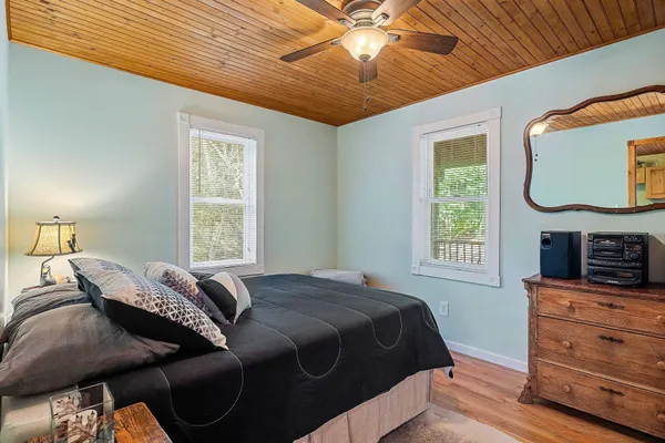 a spacious bedroom with a bed and a chandelier