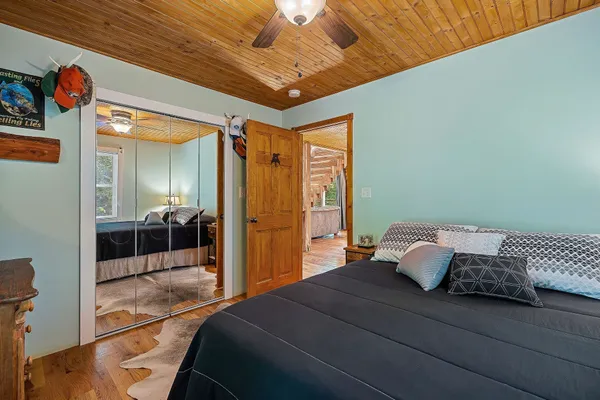a bathroom with a granite countertop sink toilet and mirror