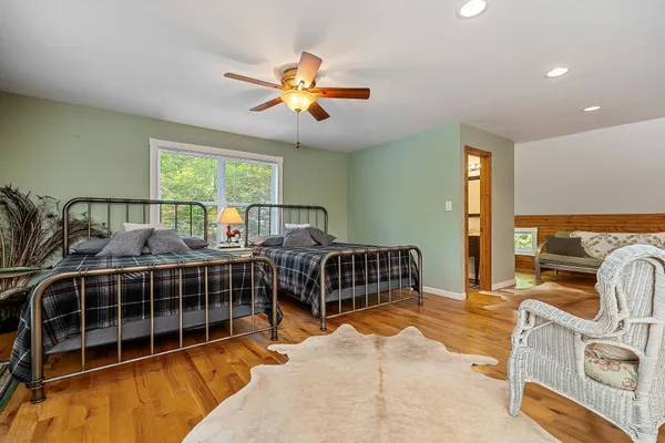 a dining room with furniture and a floor to ceiling window