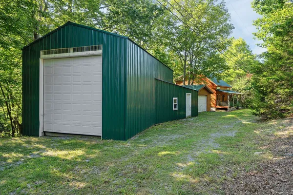 a front view of house with yard and trees