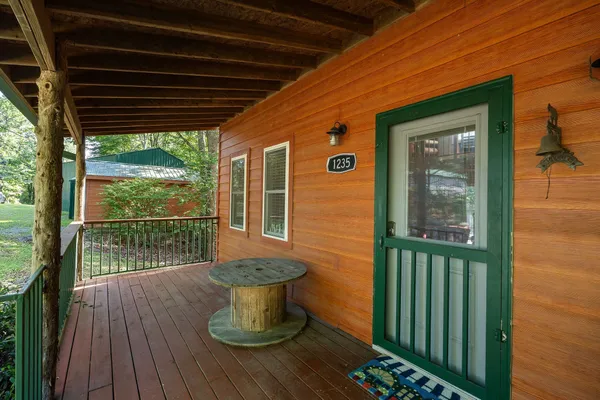 a view of a porch with wooden floor and outdoor space