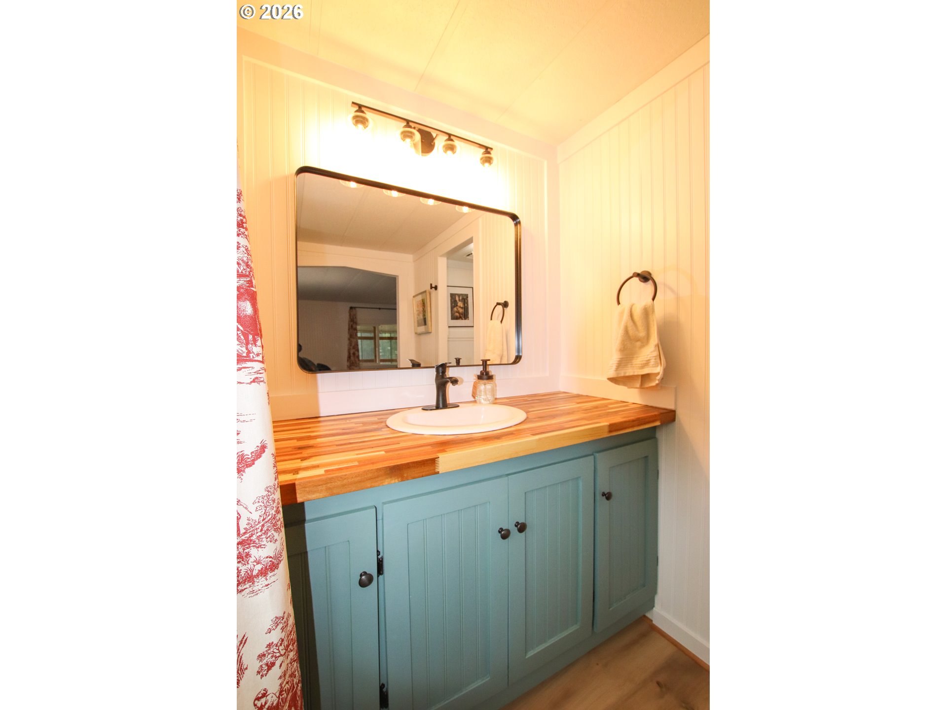 1431 Maple Street Florence, OR 97439 - Photo 31 of 43 a bathroom with a double vanity sink and mirror