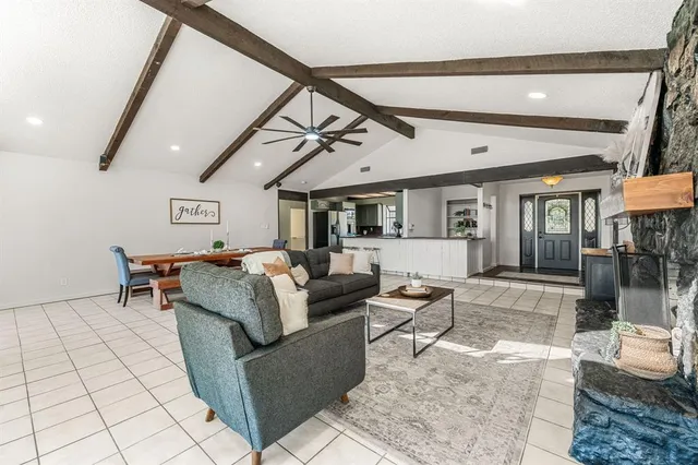 a kitchen with stainless steel appliances granite countertop a sink and a refrigerator