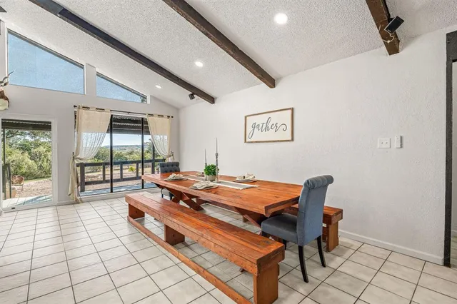 a kitchen with stainless steel appliances granite countertop a sink and a refrigerator
